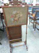 A mahogany and tapestry fire screen