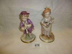 A pair of Continental porcelain musician figures