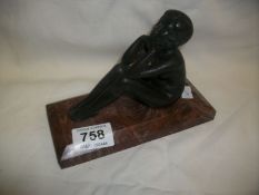 A bronze nude on marble base