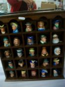 A display shelf with 25 miniature character jugs