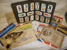 A collection of cigarette cards in albums