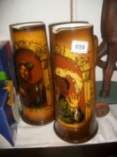 A pair of tall German pottery beer jugs (one has chip on spout)