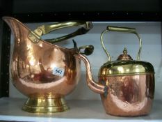 A copper helmet coal scuttle and a copper kettle