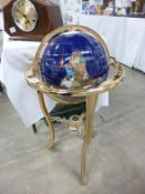 A large floorstanding jewelled globe on brass stand