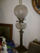 A brass Corinthian column oil lamp with glass font and etched shade