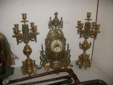 A brass 3 piece clock garniture
