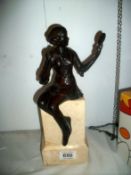 A bronze figure on marble base