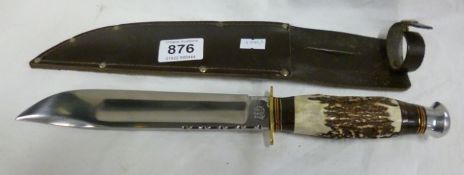 A Bowie knife in leather scabbard