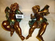A pair of gilded wall hanging cherubs