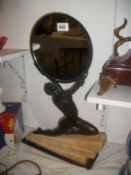 A Bronze figure holding a mirror set on a marble base
