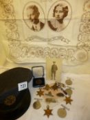 A quantity of medals, badges and a hat etc