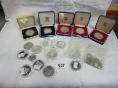 A quantity of silver coins including £5 commemoratives.