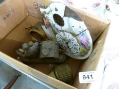 A box of old metal clock cases etc