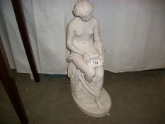 A marble figure of a woman reading