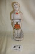 A crested WW1 figure 'bombs and more bombs' and 'doing Her bit' Leicester crest