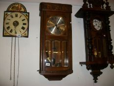 An Edwardian oak wall clock