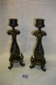 A pair of Japanese candlesticks with prunus and butterfly decoration