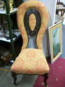 A Victorian carved ballon back hall chair