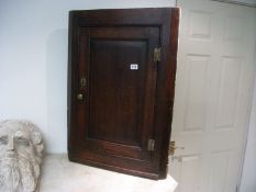 An oak corner cupboard