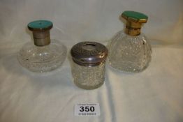 2 cut glass perfume bottles with enamel tops and a glass hair pot with silver top