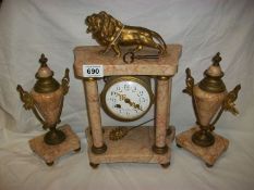 A French clock garniture surmounted lion