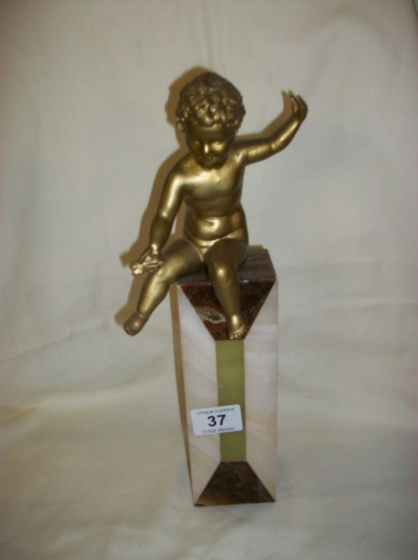 A 1930's spelter cherub on marble column, 35cm