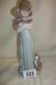 A Lladro figure of a girl with cats