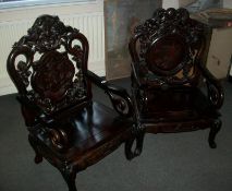 A good pair of Chinese carved arm chairs