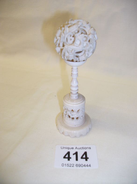 An ivory puzzle ball on stand