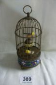 A brass birdcage two bird automation clock decorated with cloissonne enamel