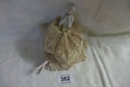 A Victorian pin cushion doll in original dress and with feet