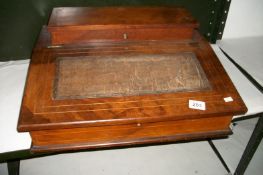 A lap top writing desk with sloping top