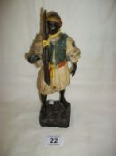 An 1870's cold painted blackamoor figure with rifle, a/f