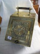 A Victorian brass coal box with embossed lid