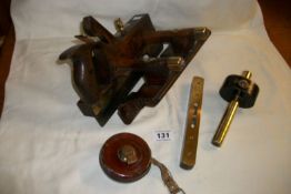 A Victorian woodworking plane, spirit level, tape measure and one other item