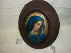 An oval convex portrait of The Maddona