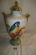 An Aynsley hand painted lidded vase 'Blue tit' signed J Shaw and still bearing the original Harrod's