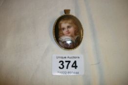 A porcelain brooch with picture of young boy