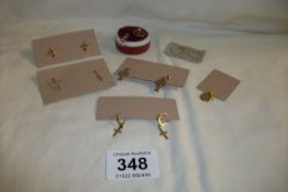 6 pairs of gold earrings and a small pendant