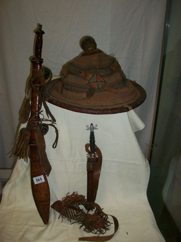 A chinese straw hat and 2 leather sheathed knives