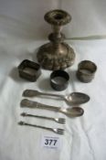 3 Silver napkin rings, 2 silver spoons, 2 small silver forks and a silver plated candlestick