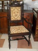 A heavily carved Grandfather hall chair