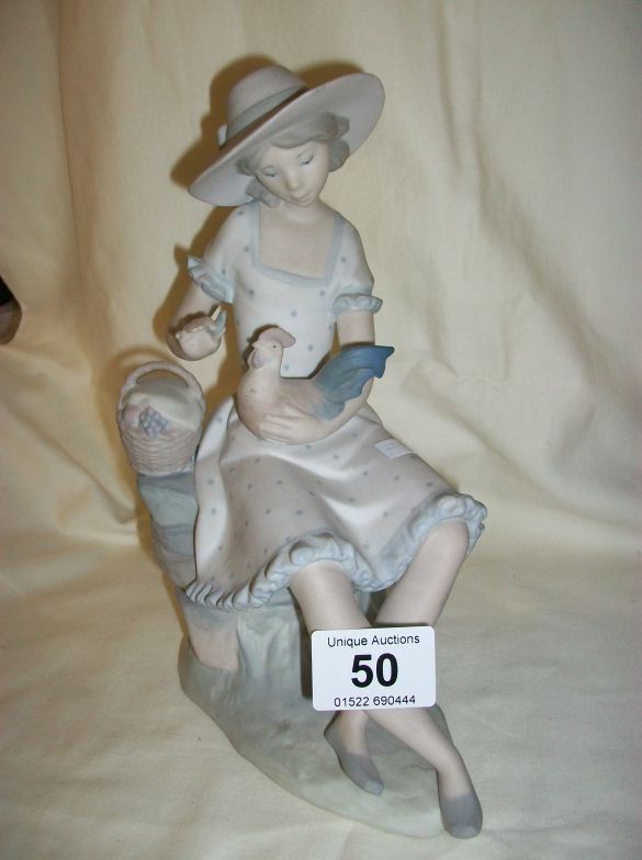 A NAO figurine of a girl holding a dove