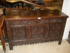 A heavily carved 19th century blanket chest