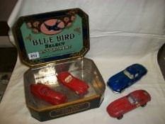 A Blue bird toffee tin containing die cast cars, mainly Jaguar