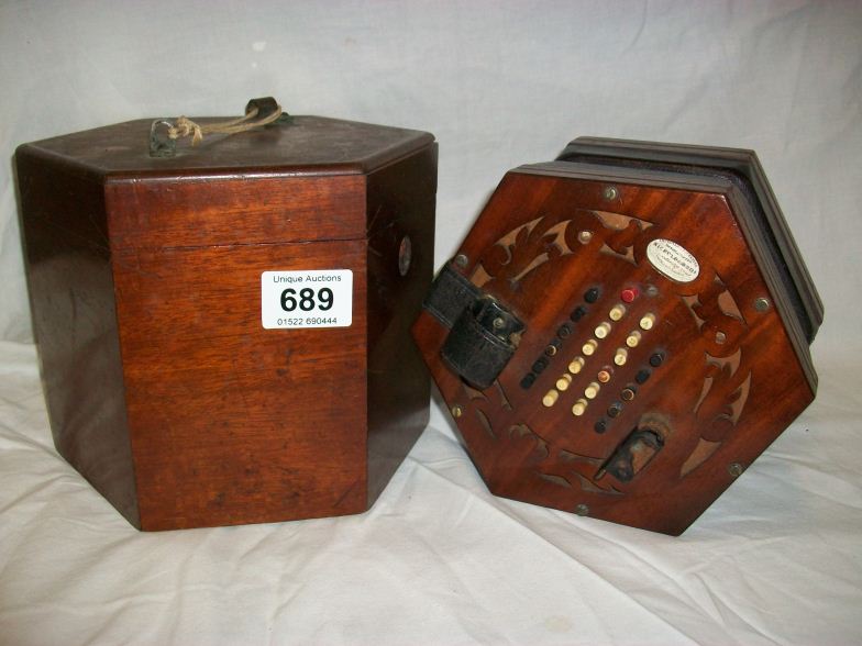 An 1870 Concertina in original case by Hickolds Bros, Clerkenwell, London