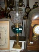 A Victorian brass oil lamp with blue glass font and etched glass shade