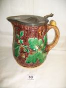 A Minton Majolica jug with pewter cover