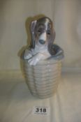 A Lladro dog in basket