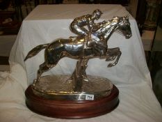 A Racehorse jumping over fence in filled silver and signed CD 1987, Bearing Hall Marks. 18" high x